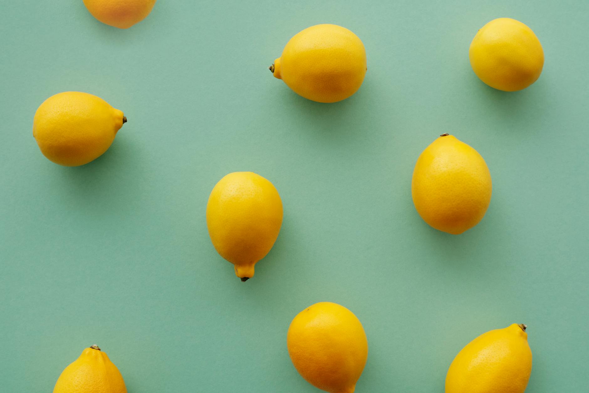 Bright yellow lemons arranged on a pastel background, symbolizing renewal and sensitivity