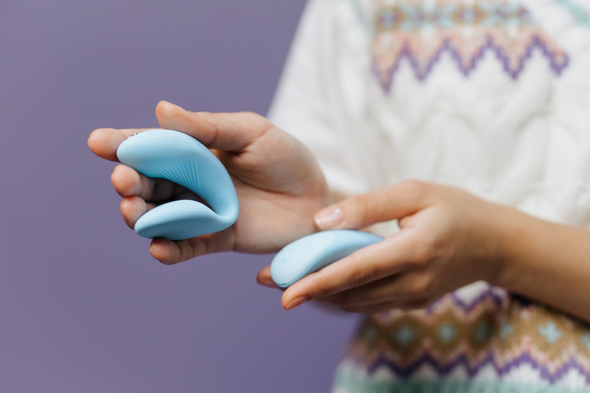 A blue silicone vibrator displayed against a purple background, emphasizing modern pleasure technology.